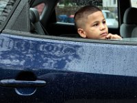 Jainyel Robles, 9, takes a look at his school for the first time from inside his car, upon arriving with his mother, as students across New Bedford return to school.  [ PETER PEREIRA/THE STANDARD-TIMES/SCMG ] [ PETER PEREIRA/THE STANDARD-TIMES/SCMG ]